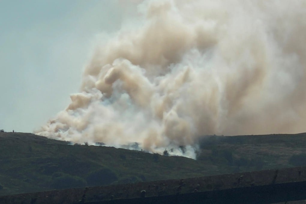 Smoke rises as a wildfire burns in Darwen, Britain, on Sunday. Photo: Andrew Robinson via Reuters