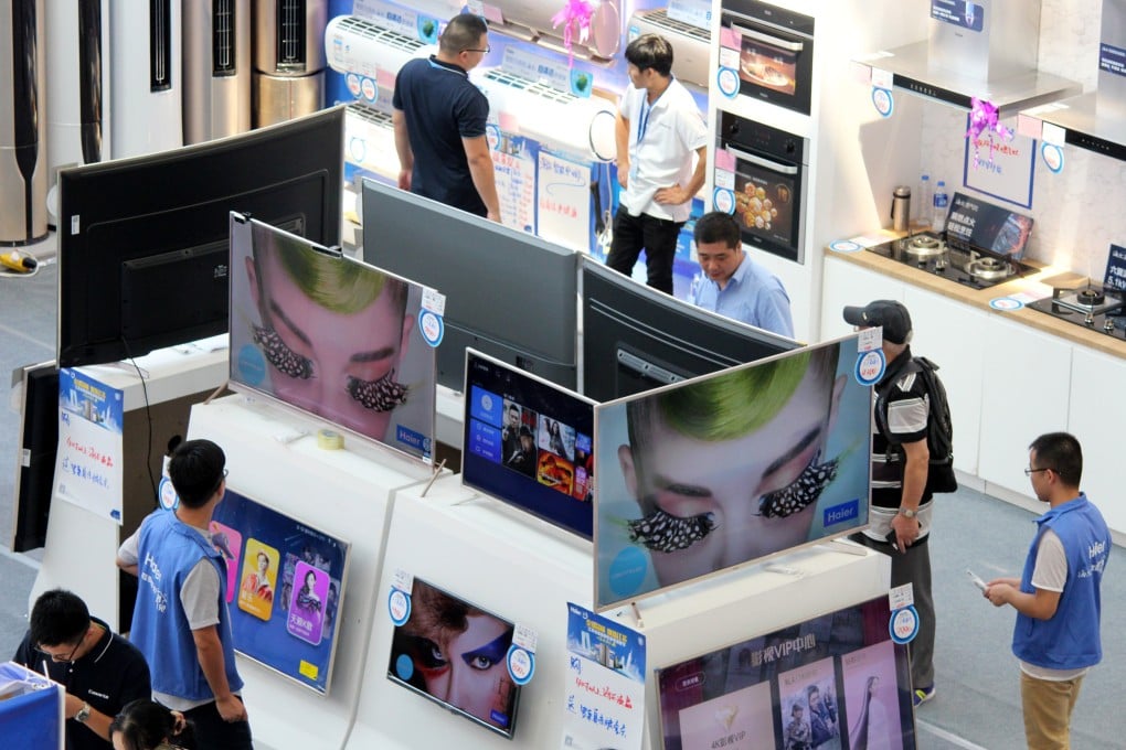 Customers check out televisions at a home appliances store in Changzhou, Jiangsu province. Photo: VCG