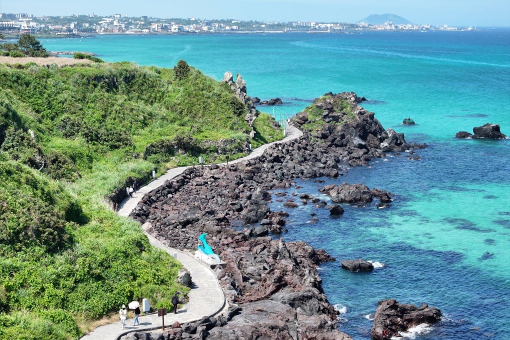 Tourists take a stroll on a trail along Handam Beach on Jeju Island, South Korea, last month. Photo: EPA/Yonhap