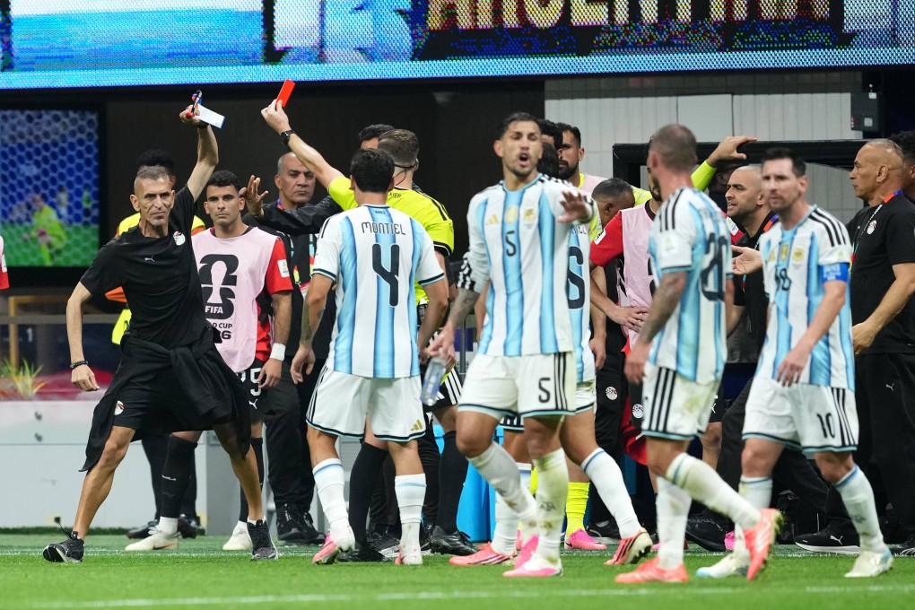 A flashpoint in the controversial Argentina v Egypt match, when referee Francois Letexier shows a red card to an Egyptian staff member. Photo: dpa