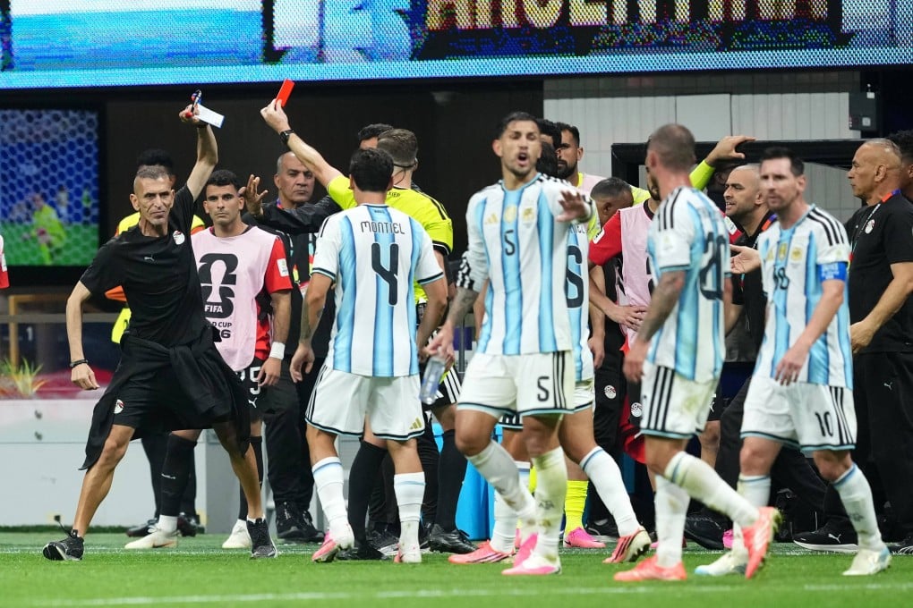 A flashpoint in the controversial Argentina v Egypt match, when referee Francois Letexier shows a red card to an Egyptian staff member. Photo: dpa