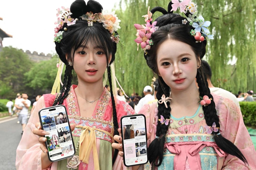 Two tourists from China’s Jilin province show their RedNote accounts on their mobile phones as they visit the Forbidden City in Beijing on July 11, 2026. The platform, also known as Xiaohongshu, has shaken up the tourism industry in China, where domestic travel is booming to record levels. Photo: AFP