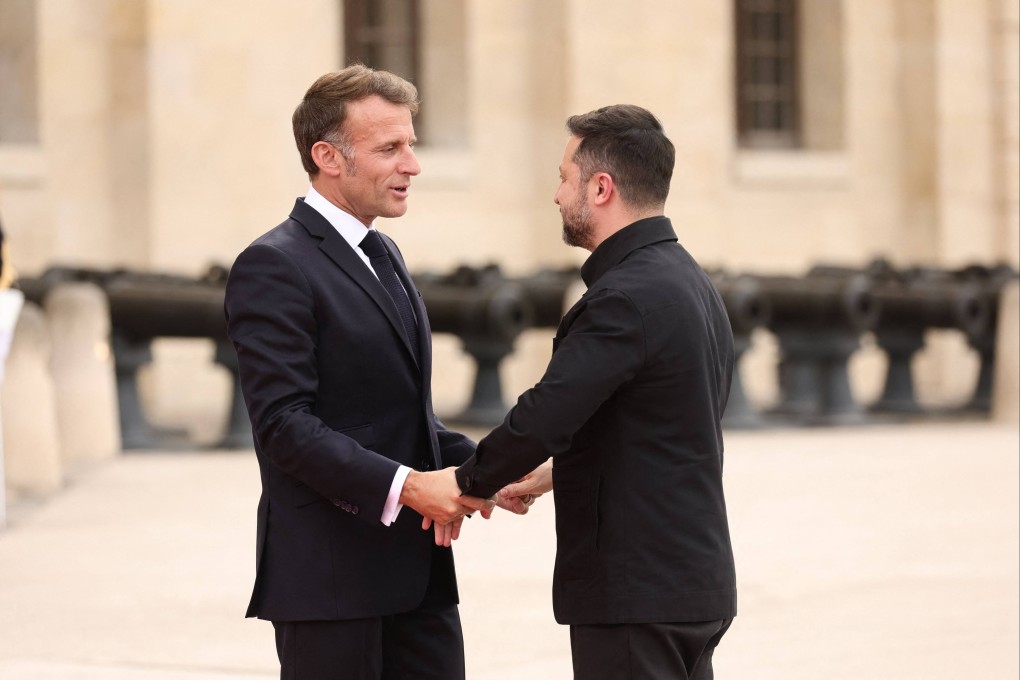 French President Emmanuel Macron, left, greets Ukrainian President Volodymyr Zelensky upon arrival for a summit of the Coalition of the Willing at the Hotel des Invalides in Paris on Monday. Photo: AFP