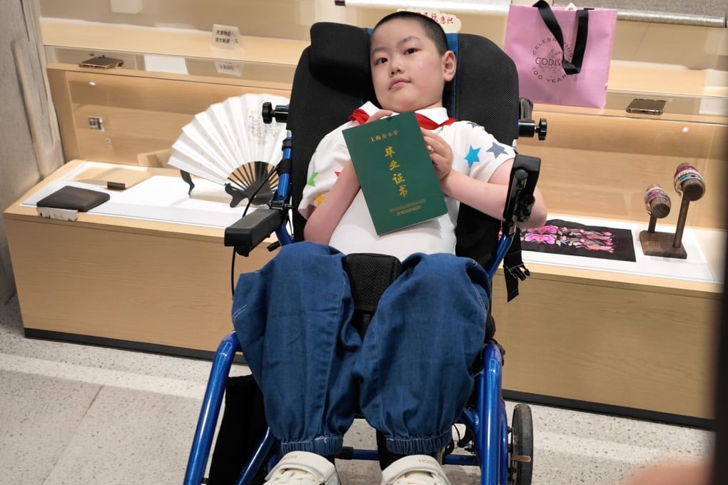 Zou Weiluo, 12, with spinal muscular atrophy - once given under three years to live - inspires millions by graduating primary school. Photo: The Paper