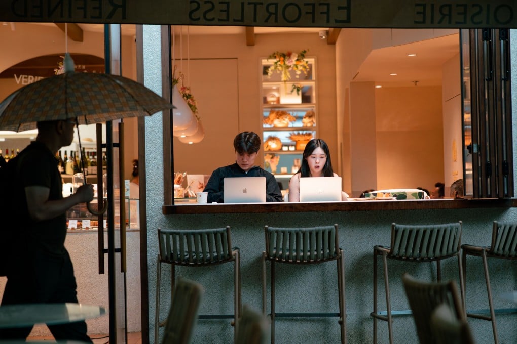 People work on their laptops at a cafe in Shanghai. As companies rush to automate, the value of an authentic voice might have been overlooked. Photo: EPA