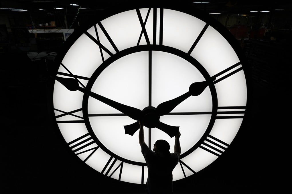 Technician Dan LaMoore adjusts a giant clock hand in Medfield, Massachusetts in March 2021. Photo: AP