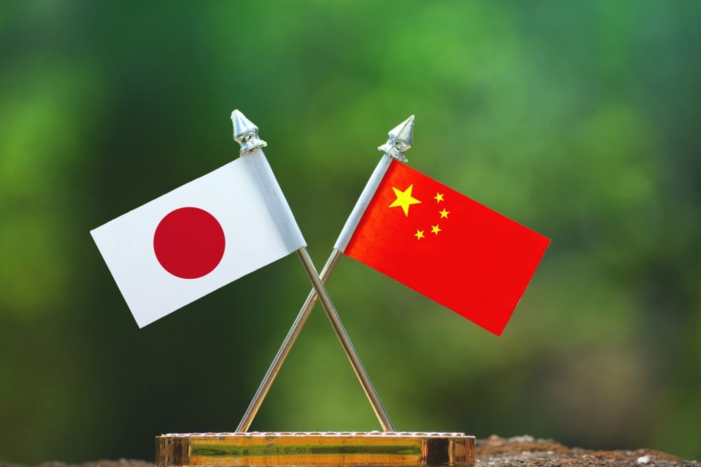Asset id: 1075372364

China and Japan small flag with blur green background. Shutterstock Images