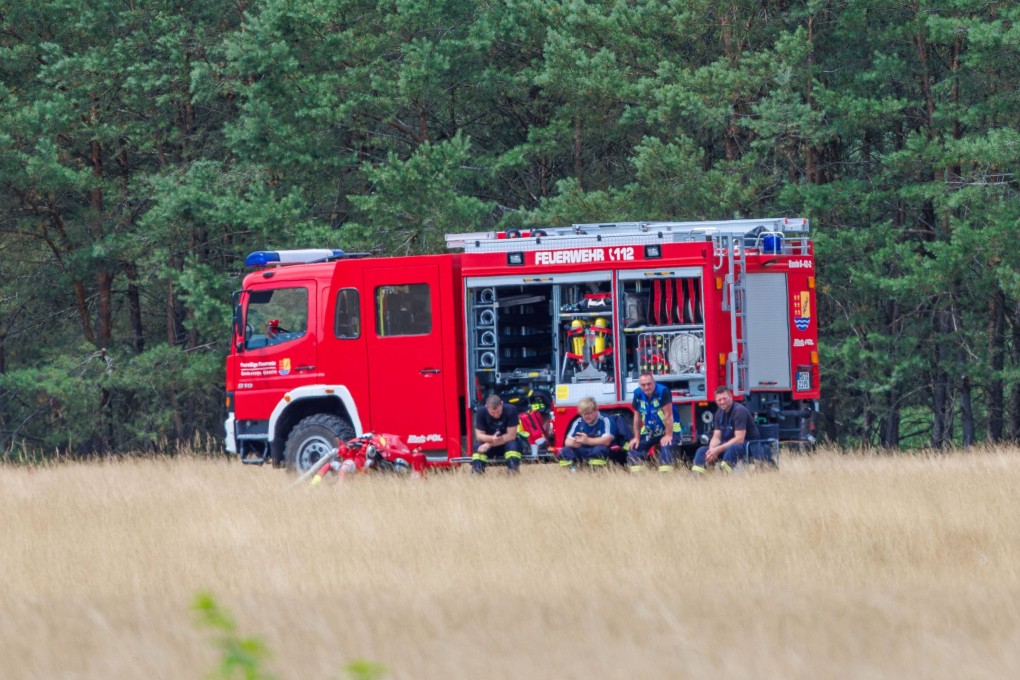 Firefighters are stationed at the edge of a forest in Mueritz National Park on Tuesday. Photo: dpa