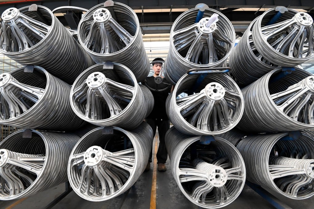 A worker inspecting the quality of a car steering wheel frame at an enterprise in Handan city, Hebei province, China, on July 15, 2025. Photo: Getty Images