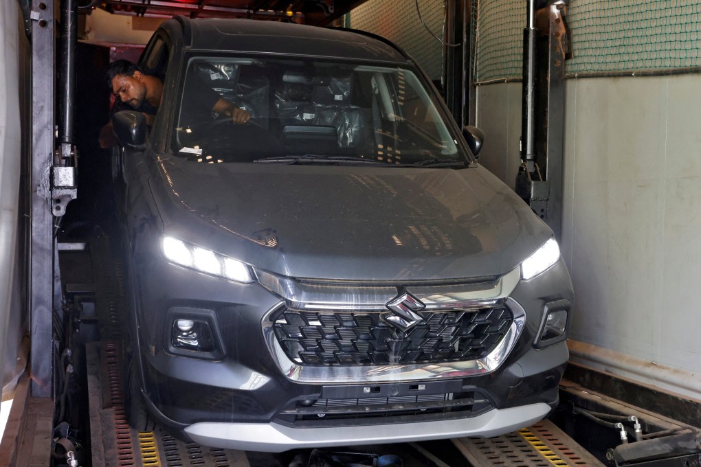 A worker unloads a Grand Vitara car from a container at a Maruti Suzuki stockyard on the outskirts of Ahmedabad, India, on October 9, 2024. Photo: Reuters