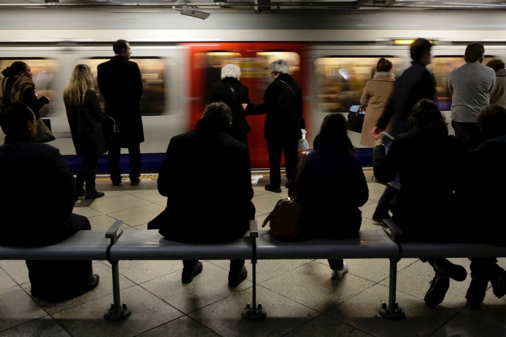 People wait for trains at Westminster Tube station in London. Photo: Reuters