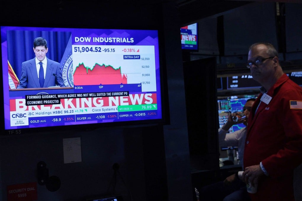 A television displays Kevin Warsh, chairman of the US Federal Reserve, speaking at a press conference as traders work on the floor of the New York Stock Exchange on June 17. Warsh spoke about the Federal Reserve decision to keep interest rates unchanged for the fourth time this year. Photo: AFP