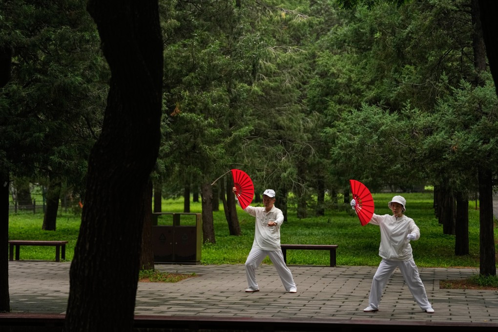 An elderly couple practice tai chi at a park in Beijing. Photo: AP