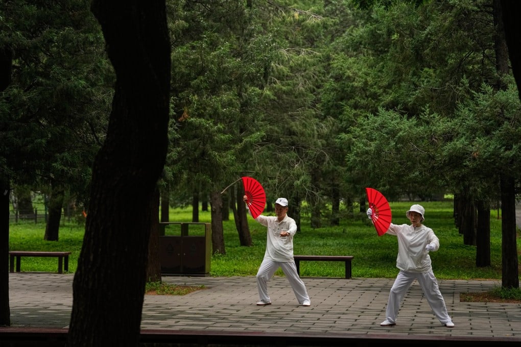 An elderly couple practice tai chi at a park in Beijing. Photo: AP