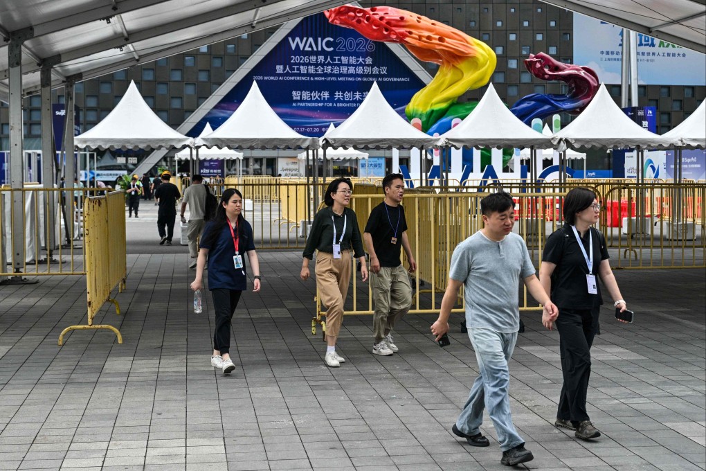 People walk near the entrance of the the Shanghai World Expo Exhibition and Convention Center, venue for the World Artificial Intelligence Conference, in Shanghai on July 16. Photo: AFP