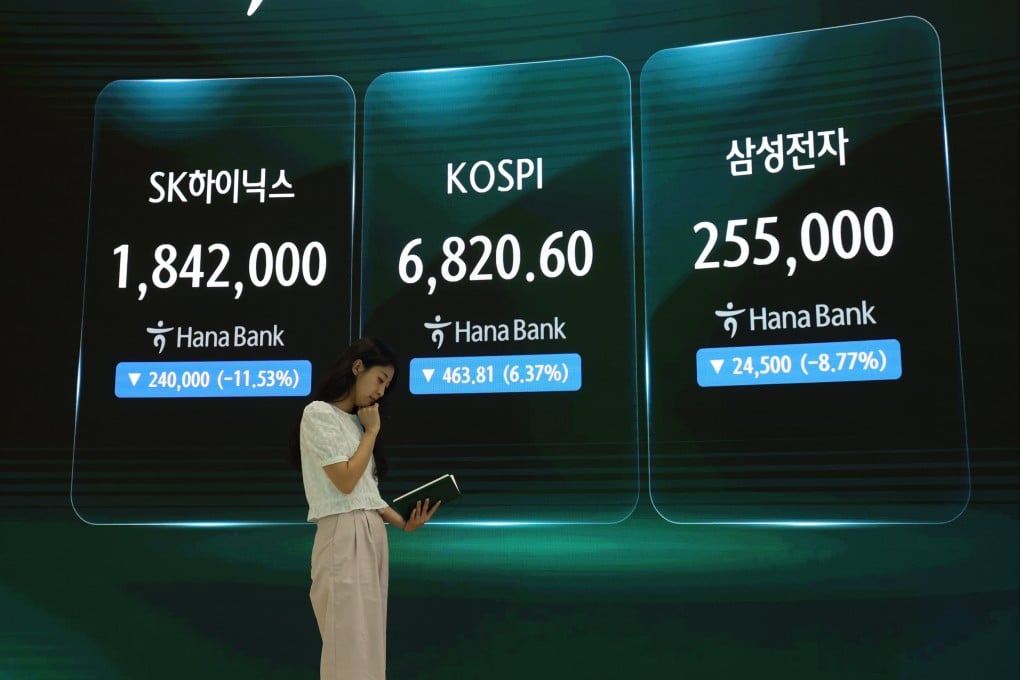 A woman is seen near an electronic signboard in the dealing room of Hana Bank in Seoul on Thursday. The Korea Composite Stock Price Index (Kospi) recently slid into a technical bear market. Photo: EPA