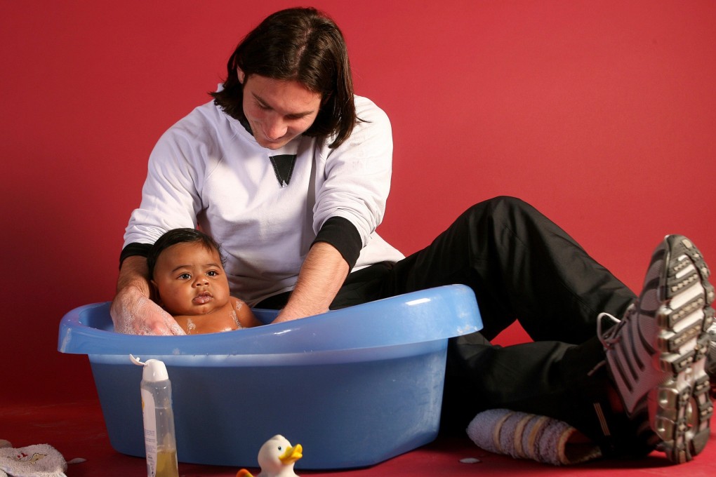 Lionel Messi, then 20, helps to bathe Lamine Yamal, who was six months old, during a photo shoot in the dressing room of Barcelona's Camp Nou stadium in 2007. Photo: AP