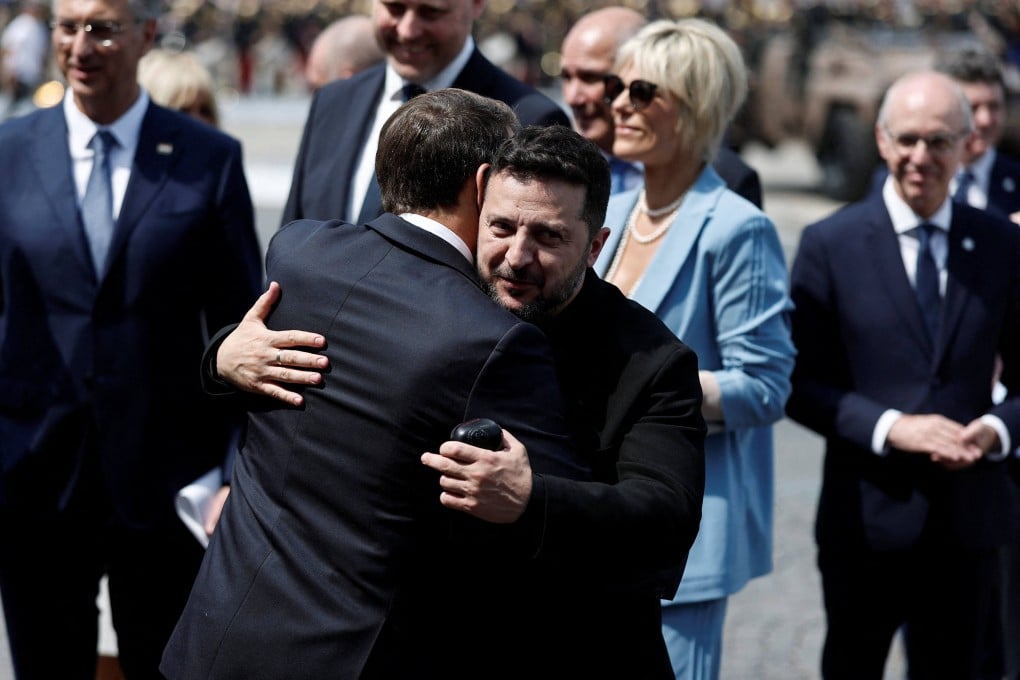 French President Emmanuel Macron hugs Ukrainian President Volodymyr Zelensky after the annual Bastille Day military parade in Paris on Tuesday. Zelensky has pressed European allies to boost Kyiv’s air defences before winter. Photo: AFP