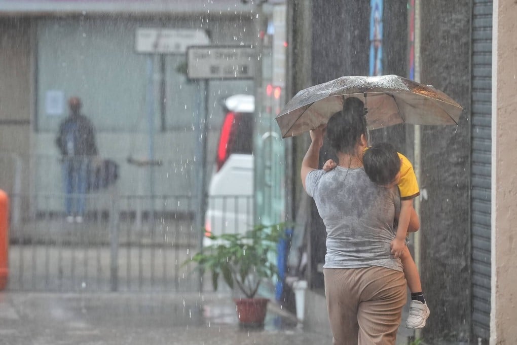 Pedestrians brave the rain in To Kwa Wan. Photo: Elson Li