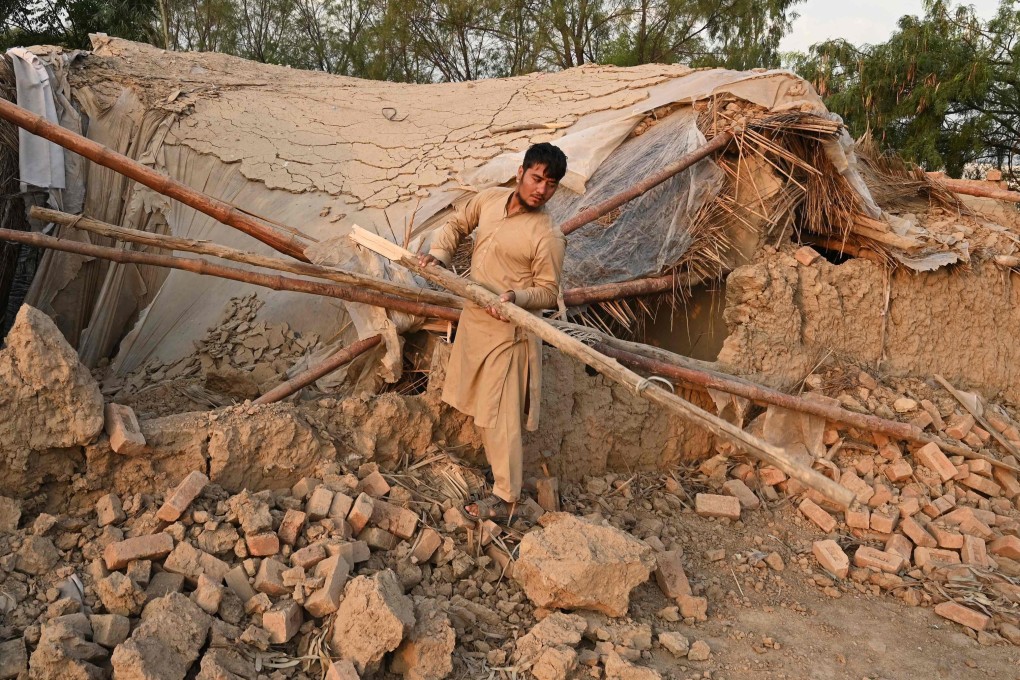A man collects building materials in Peshawar before his repatriation to Afghanistan on Tuesday. Photo: AFP