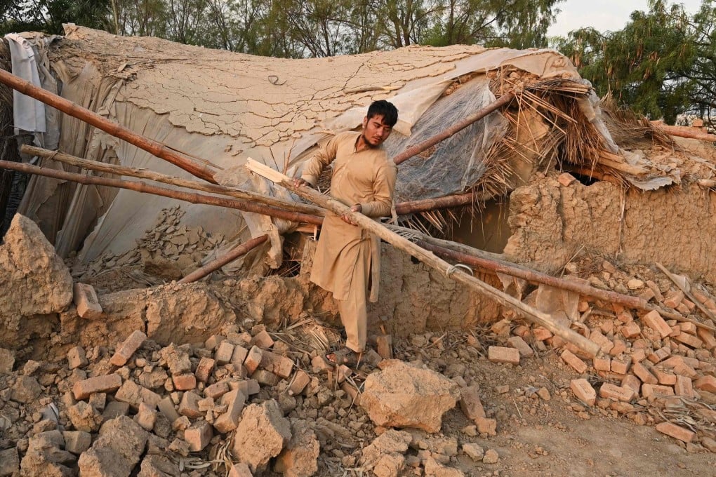 A man collects building materials in Peshawar before his repatriation to Afghanistan on Tuesday. Photo: AFP