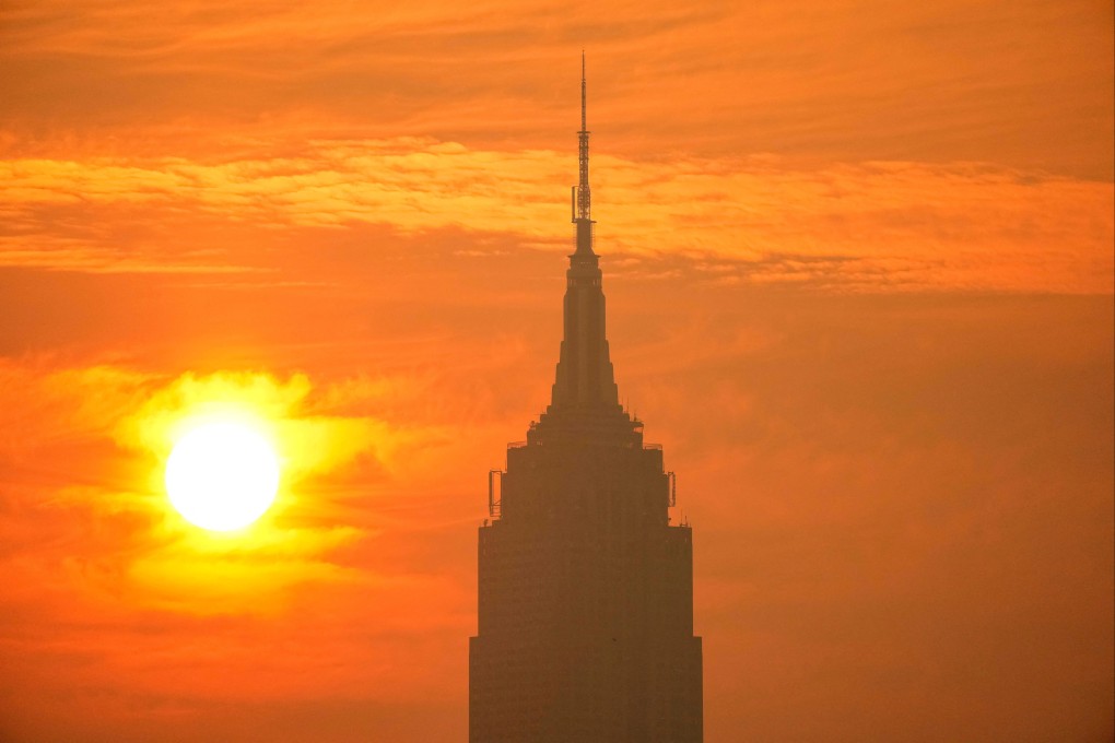 The sun rises next to The Empire State Building through a cover of wildfire smoke on Friday. Photo: Reuters