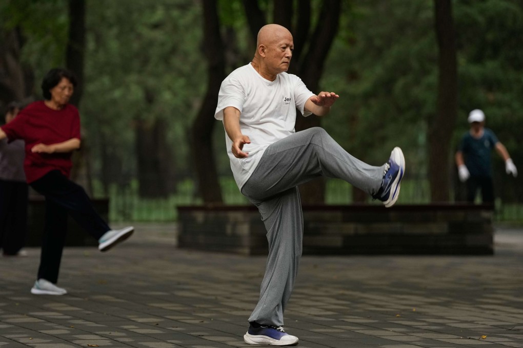 People practice tai chi in a park near the Temple of Heaven in Beijing, China. Photo: AP Photo/Andy Wong