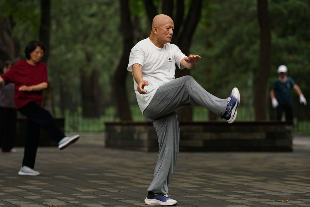 People practice tai chi in a park near the Temple of Heaven in Beijing, China. Photo: AP Photo/Andy Wong