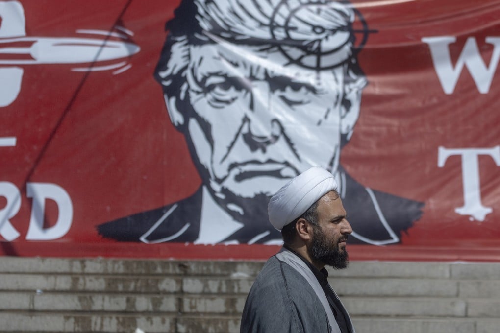 A man walks past a large banner depicting US President Donald Trump with a target on his head, during funeral ceremonies for Iran’s slain leader Ayatollah Ali Khamenei at the Grand Mosalla on July 5. Photo: TNS