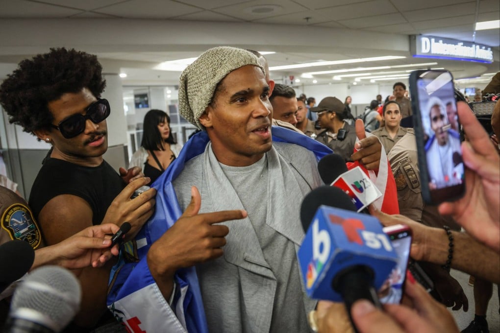 Luis Manuel Otero Alcantara, artist and opponent of the Cuban regime, speaks to members of the press upon his arrival at Miami International Airport on Saturday. Photo: AFP