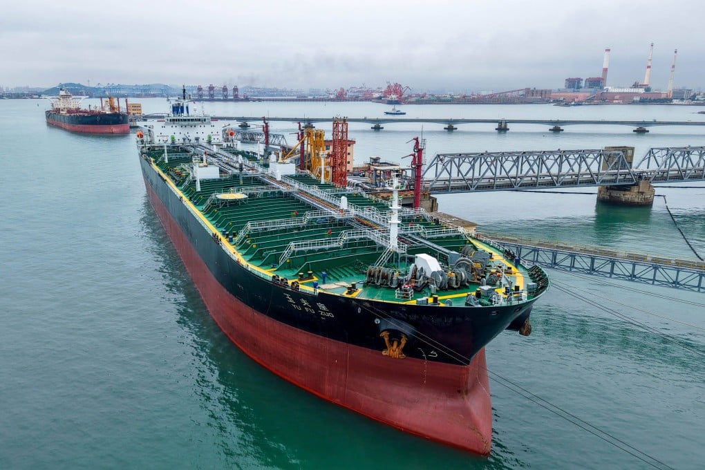 An oil tanker unloads imported crude at Qingdao port, in Chinas eastern Shandong province, on July 16. Photo CN-STR / AFP