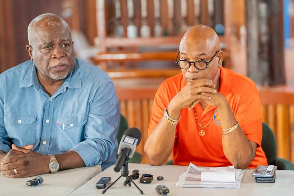 Guyana’s Prime Minister Mark Phillips, left, and Public Works Minister Juan Edhill during a press conference in the capital Georgetown on Sunday after a ferry capsized. Photo: NCN Guyana / AFP / Handout