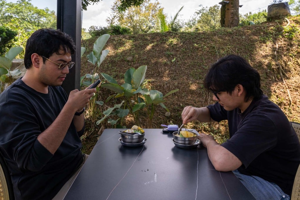Customers eat Musang King durian desserts in Karak, Pahang, on June 27. Photo: AFP