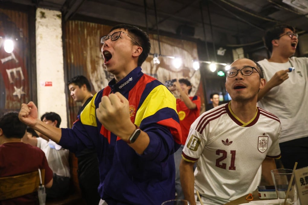 Supporters of Spain celebrate their team’s win at a bar in Beijing on Monday morning. Photo: EPA