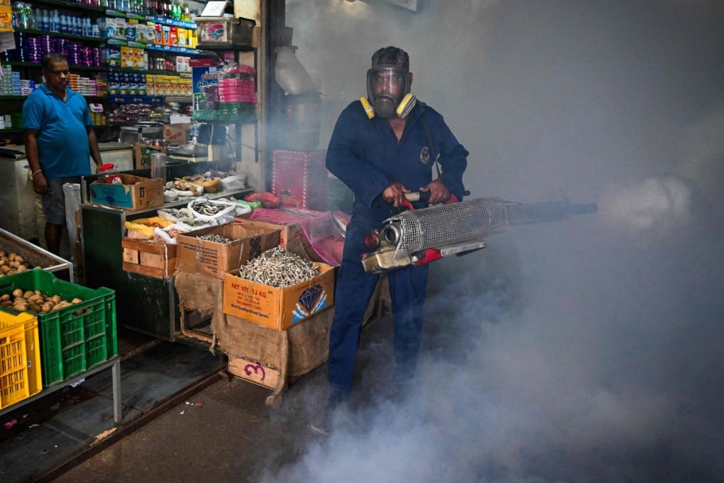 A municipal worker fumigates a market area  in Colombo on Wednesday. Photo: AFP