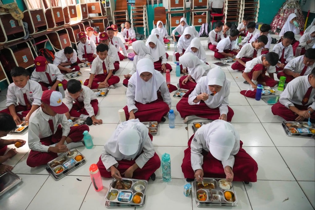 Students sit on the floor as they have their meals as part of President Prabowo Subianto’s free meal programme to feed children and pregnant women nationwide, in Banten, Indonesia in 2025. Photo: AP