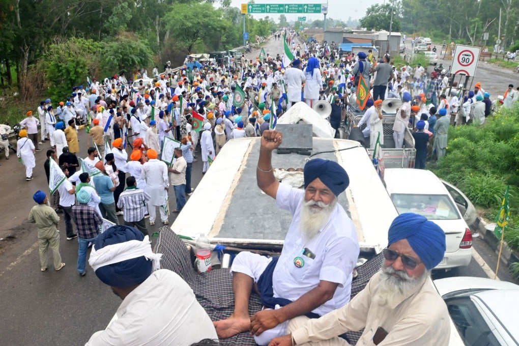 Farmers gather on a highway in Punjab, India on Tuesday after police seal a border crossing to prevent them from proceeding towards New Delhi, where thousands are protesting against a potential US-India trade deal. Photo: Reuters