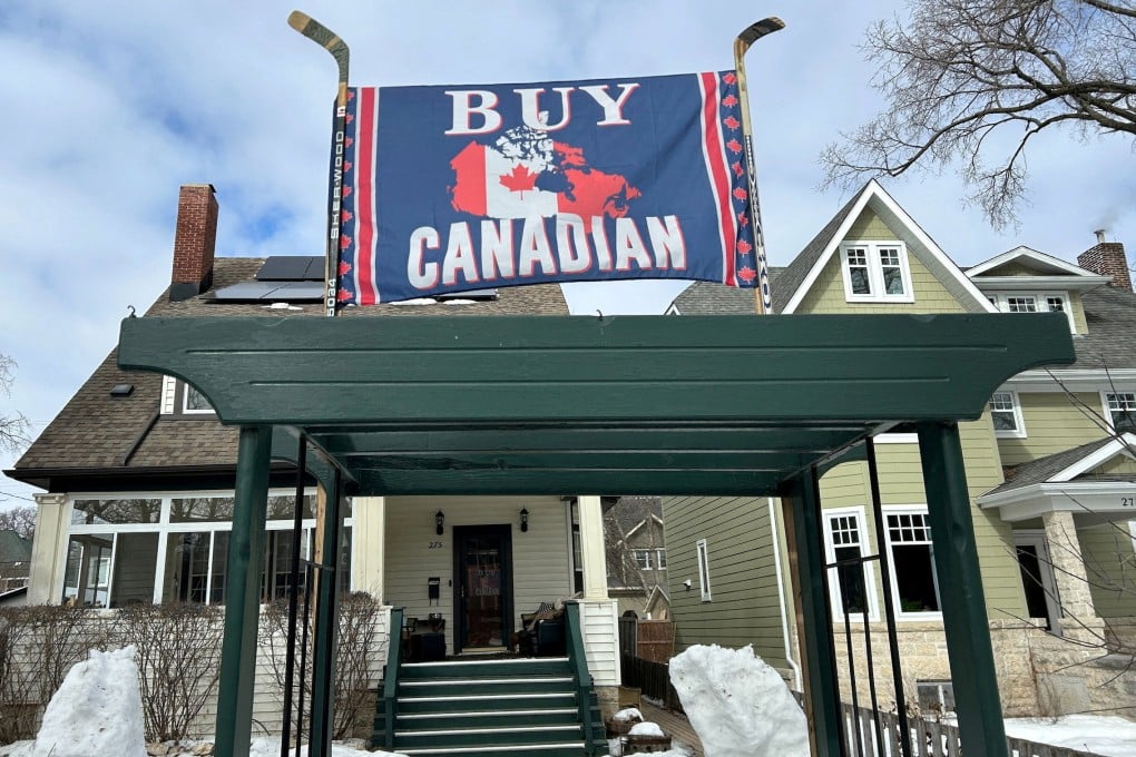 A banner reading “Buy Canadian”, in response to US President Donald Trump’s tariffs on goods from Canada, is held aloft by a pair of hockey sticks in front of a house in Winnipeg, Manitoba, in March 2025. Photo: Reuters