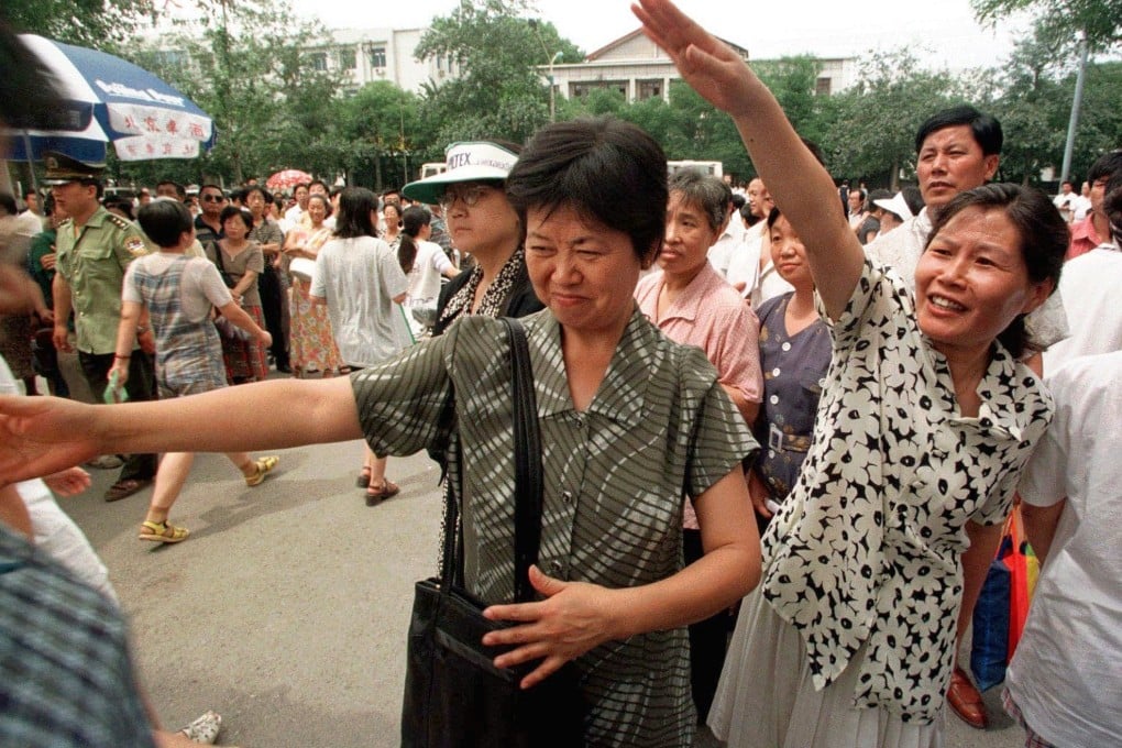 Anxious parents wave as their children emerge from the National Higher Education Entrance Examination at a high school in Beijing in 1998. In Chinese society in the 1980s and 1990s, the self-sacrificing mother could be seen and heard everywhere. Photo: AP