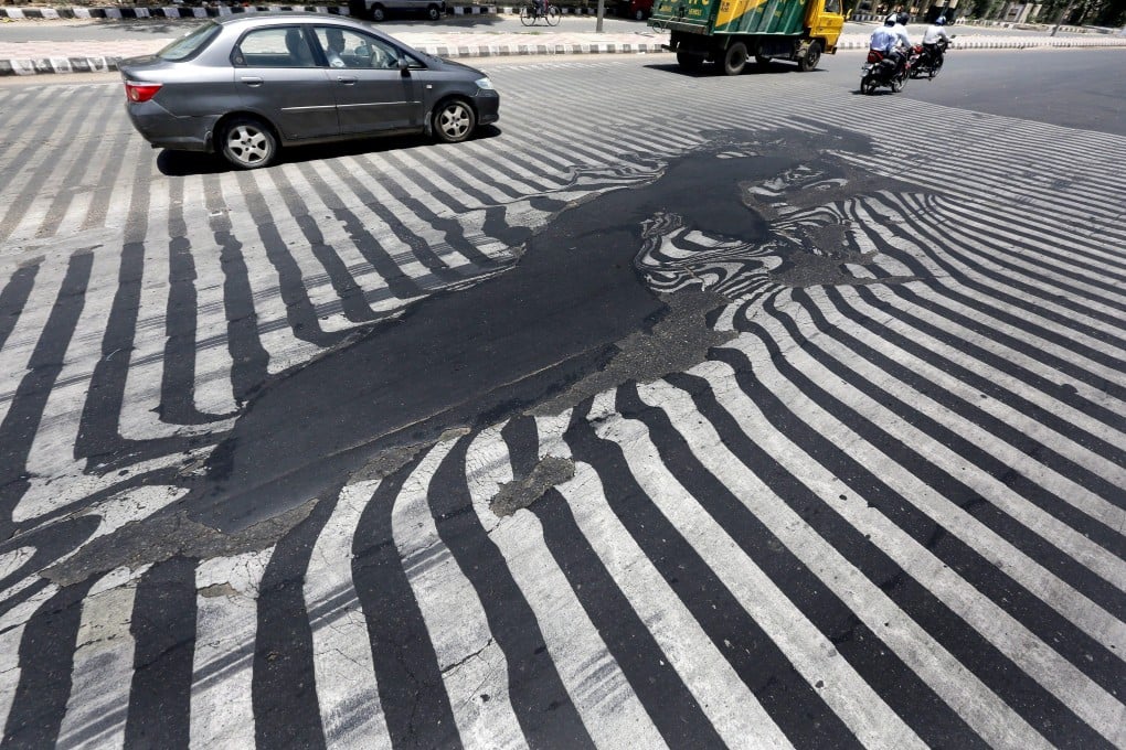 Melting asphalt, like this seen in India in the 2015 heatwave, is now increasingly common. Photo: EPA