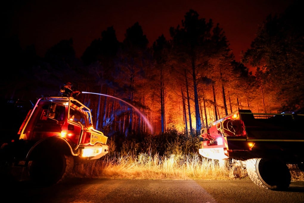 Firefighters douse flames in Le Porge as wildfires sweep through the Gironde region of southwestern France. Photo: Reuters