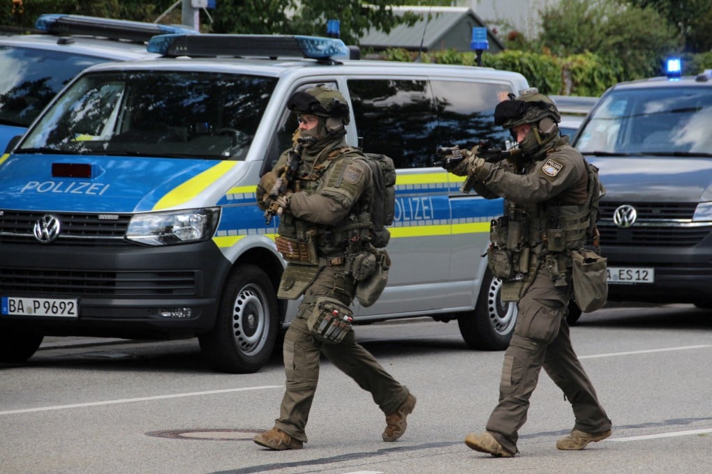 Special police walk towards a suspected hostage-taking situation in a bank in Regensburg, Germany on Thursday. Photo: Reuters