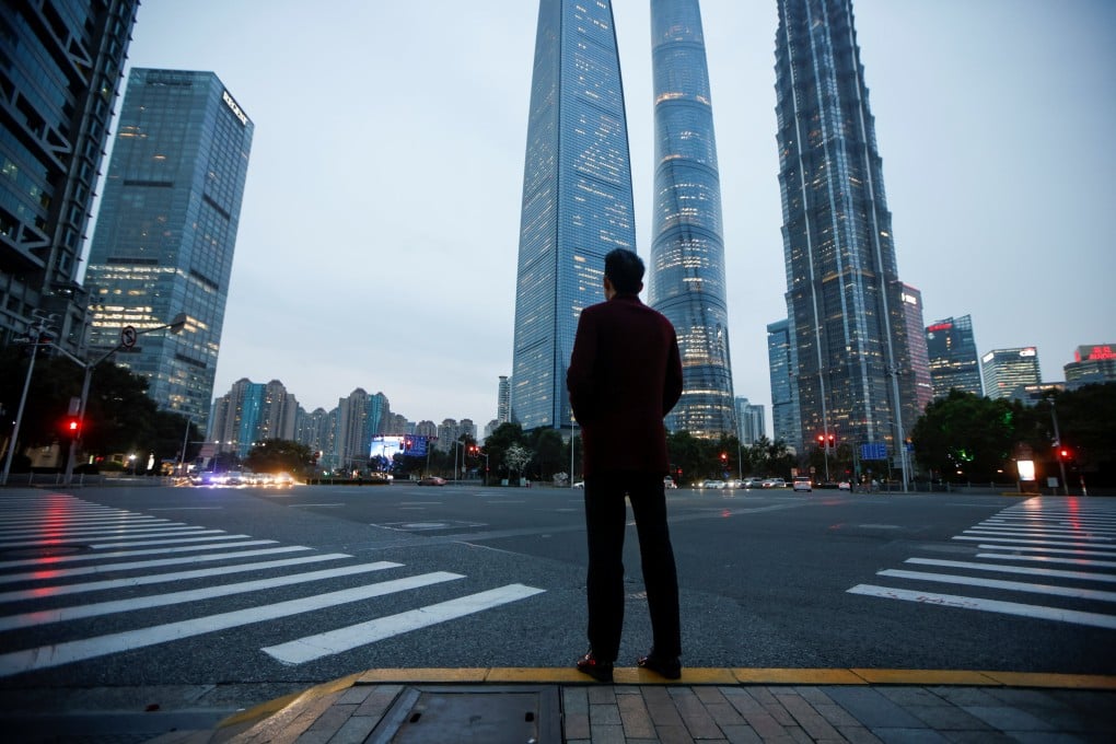 A man stands at a crossroads in Lujiazui financial district in Pudong, Shanghai, on March 5, 2021. Photo: Reuters