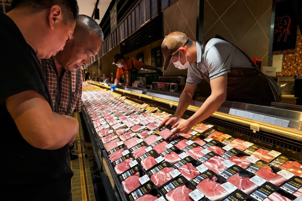 Customers shop at the pork section of a Pangdonglai supermarket in Xuchang, Henan province on  on May 14. Pangdonglai has attracted public attention for its customer service and retail management practices. Photo: Cheng Xin