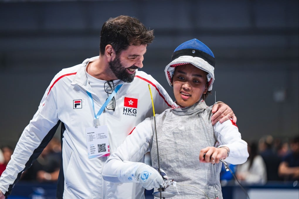 Greg Koenig (left) congratulates foilist Daphne Chan after her preliminary knockout victory at the AsiaWorld-Expo on Friday. Photo: Fencing Association of Hong Kong, China