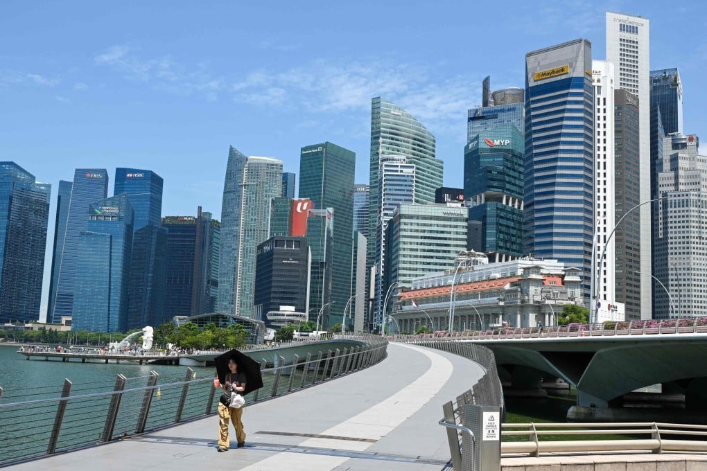 A woman walks past Singapore’s financial business district on May 19. Photo: AFP