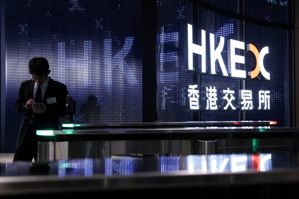 A man stands near the logo of Hong Kong Exchanges and Clearing, at its hall in Hong Kong on July 8. Photo: Reuters
