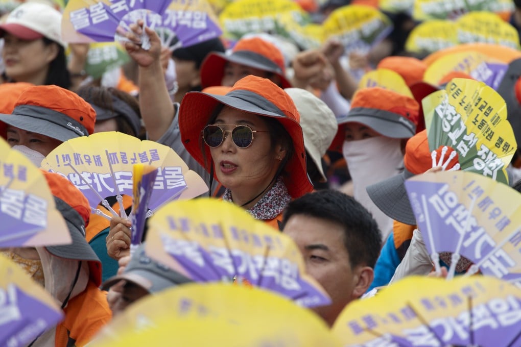Members of the South Korean Confederation of Trade Unions hold signs reading “basic labour rights” during a rally in Seoul on July 16. Photo: EPA