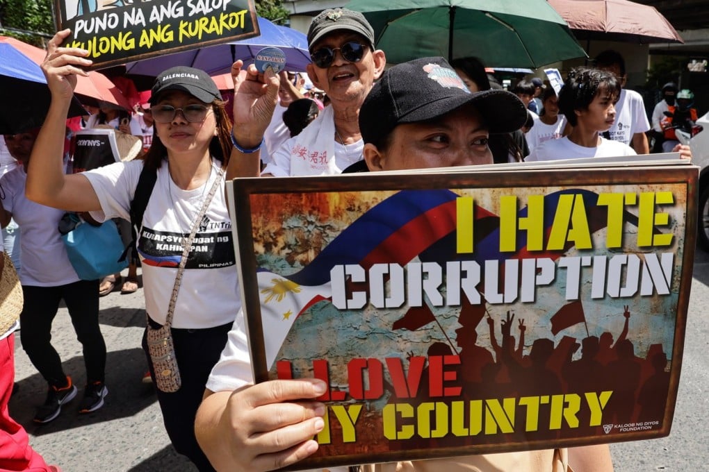 A protester holds a sign during an anti-corruption rally in Quezon City, Metro Manila, Philippines, last month. Photo: EPA