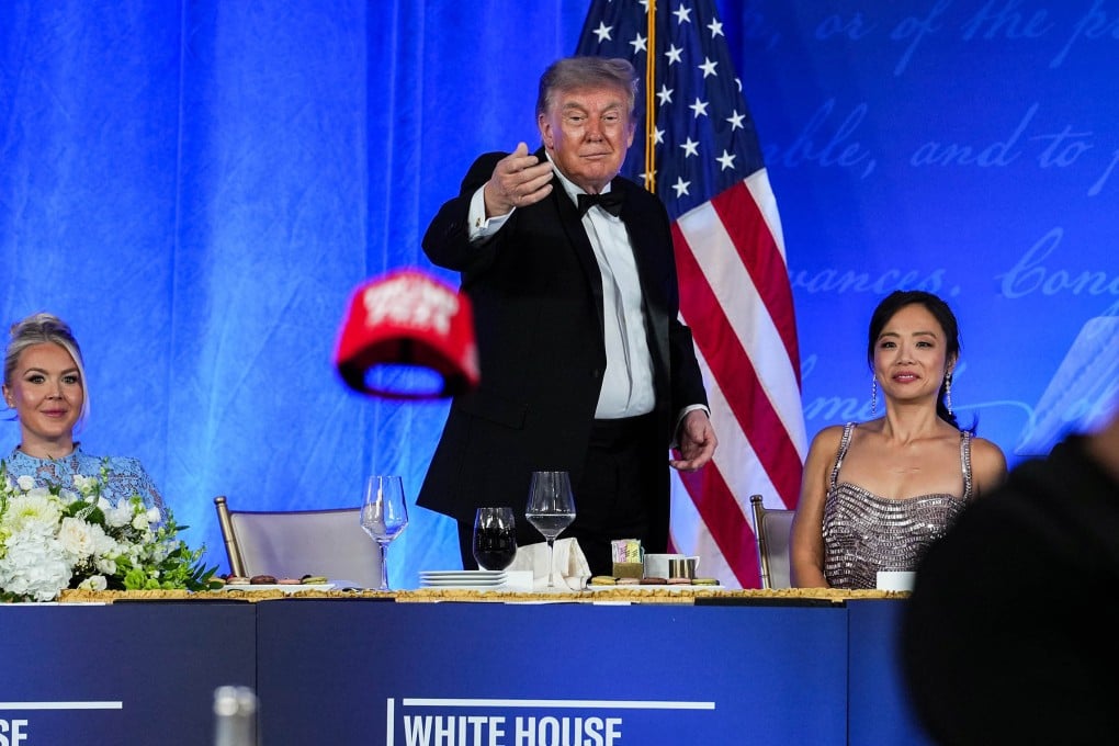 US President Donald Trump tosses his Trump 2028 hat to an attendee during the White House Correspondents Dinner on Friday. Photo: Getty Images/TNS